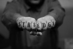 two hands with the word struggle written on them, in front of a man's face