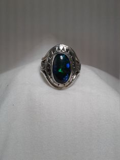 Beautiful blackl opal (3/8 x 5/8) 9 x 16mm with patterned sterling silver band and decorative bezel.  Made with Sterling, Fine silver and Argentium silver. Lots of green and blue flash in opal.  Terrific  gift for the October birthday or Christmas gift. This is a one of a kind ring so only available in size 7 1/2. I have other black opals but they are not as large as this one.  If you are interested in having a ring made with a smaller black opal, contact me. Oval Ring Silver, Oval Opal Ring, Black Opal Ring, Rings Black, Erie Pa, Lapis Lazuli Earrings, Ring Opal, Oval Ring, Oval Rings