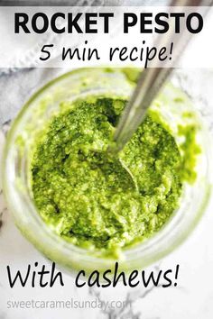 pesto sauce in a jar with a spoon on the side and text overlay that reads, arugula pesto recipe