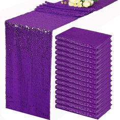 purple sequin table runners with white flowers on the top and one in the middle