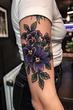 a woman's arm with purple flowers on it