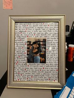 a couple kissing in front of a bookshelf with love written all over it