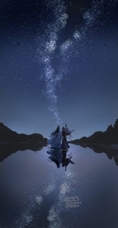 two people standing on the edge of a body of water under a night sky filled with stars