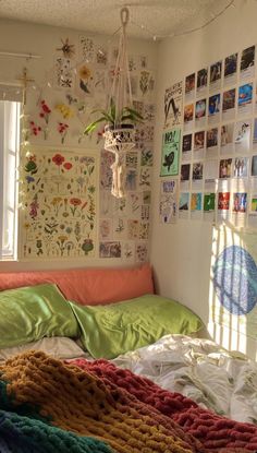 a bedroom with many pictures on the wall