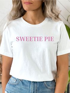 This t-shirt says it all - Sweetie Pie.  Perfect for your sweetie. Quality unisex-size Bella+Canvas tee is made from premium, lightweight fabric. This casual t-shirt is soft and cozy, featuring a comfortable crew neck, short sleeves, and a relaxed, modern style. Available in sizes ranging from Small to 3XL, there's a perfect fit for everyone.  For an oversized, slouchy fit, we recommend ordering up. Please see size guide in the listing photos for all measurements. The shirt is made from 100% air Cute Slogan Crew Neck T-shirt, Cute Crew Neck T-shirt With Slogan, Cute Slogan T-shirt With Crew Neck, Sweet Tops With Funny Print And Crew Neck, Cute Crew Neck T-shirt With Text Print, Cute Crew Neck T-shirt With Custom Text, Trendy Custom Text T-shirt With Crew Neck, Trendy Custom Text Crew Neck T-shirt, Trendy Crew Neck T-shirt With Custom Text