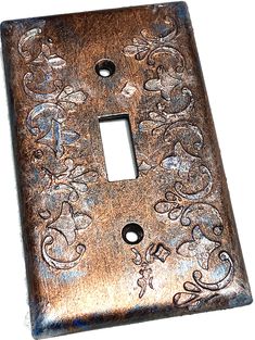 a decorative light switch cover with an ornate design