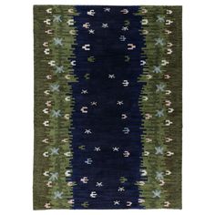 a green, blue and black rug with stars on the bottom is shown in front of a white background