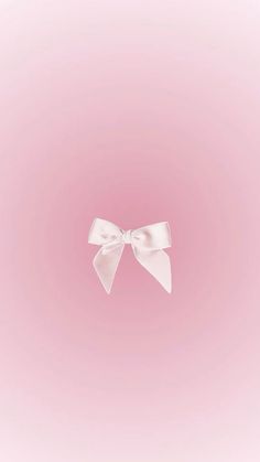 a white bow on a pink background