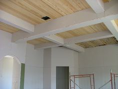 an unfinished room with scaffolding on the ceiling