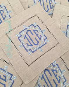 four blue monogrammed napkins on top of each other