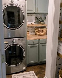 a washer and dryer in a laundry room next to each other with baskets on the floor