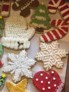 many decorated cookies are sitting on a table with snowflakes and candy canes