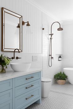 a bathroom with blue cabinets and white walls