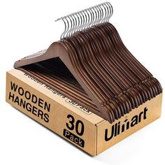 wooden hangers in a cardboard box on a white background