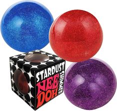 three different colored balls sitting next to each other on top of a cardboard box with the words stardust and jee doh