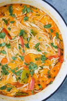 a large pot filled with noodles and vegetables