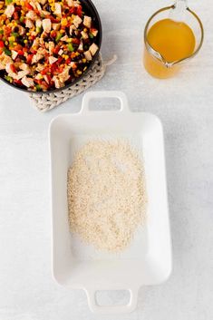 ingredients to make chicken and rice casserole laid out on a white counter top