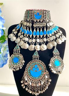 Afghan light blue vintage 3 piece jewellery set, Afghan jewellery  Set includes: -1 pair of earrings  -1 chocker necklace  -1 tikka  Message for any enquiries Our Aim as a business is to connect Afghan women with their roots and to make anyone that purchases our jewellery feel powerful and beautiful as each and everyone of our items is handcrafted with care and love. Unique Blue Jewelry For Festivals, Blue Handmade Vintage Choker, Vintage Blue Handmade Choker, Blue Vintage Necklace For Festival, Vintage Blue Jewelry For Festivals, Blue Vintage Jewelry For Festivals, Vintage Blue Choker Jewelry, Blue Metal Jewelry For Festivals, Vintage Jewelry Sets For Weddings And Festivals