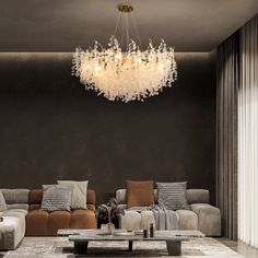 a living room with couches, tables and a chandelier hanging from the ceiling