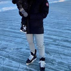 a man holding a child in the snow