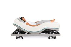 a man laying on an inflatable bed with wheels attached to the backrest