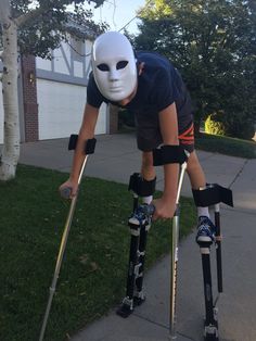 a man wearing skis and a mask on top of his head while leaning over