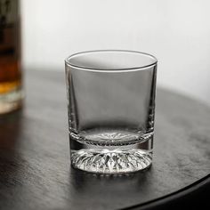 a glass sitting on top of a wooden table