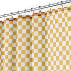 a yellow and white checkered curtain hanging from a metal rod