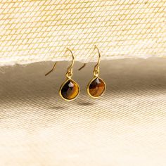 Tiger's Eye Mini drop charms 14k gold filled earwire earrings - Handmade elegant, everyday, casual gemstone gift earrings for every occasion Stone: Genuine Tiger's Eye Heart Gemstone: 11mm x 9mm Total length of Earrings: 20mm Ear-wires: 14K gold Filled Bezel: Vermeil Gold About "Gold Filled Jewelry": Also called rolled-gold. These jewelry items are not actually filled with gold. They are made of a base metal covered by sheets of gold in a mechanical bonding process. Effectively a thick coat ... Thick Coat, Heart Gemstone, Tiger's Eye, Gold Filled Jewelry, Base Metal, Earring Gifts, Tiger Eye, Ear Wires, Gemstone Earrings