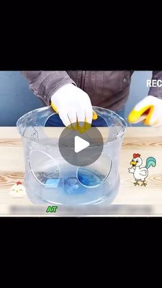 a person in white gloves is cleaning a bucket with blue liquid and yellow sponges