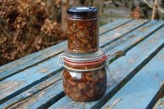 a jar filled with nuts sitting on top of a wooden table