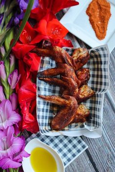 some food is sitting on a table with flowers