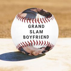 a baseball with the words grand slam boyfriend on it and a woman kissing her face