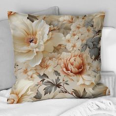 a pillow with flowers on it sitting on a bed