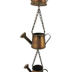 an old fashioned watering can is suspended from chains to hold two buckets and a pipe