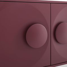 a purple cabinet with two round knobs on the front and one in the back