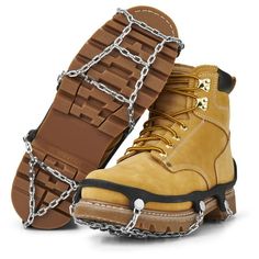 a pair of yellow boots with chains on the soles and one boot is brown