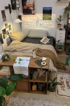 a bed room with a neatly made bed and lots of plants