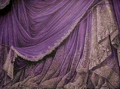 an image of purple curtains with laces on the top and bottom, as if they were drapes