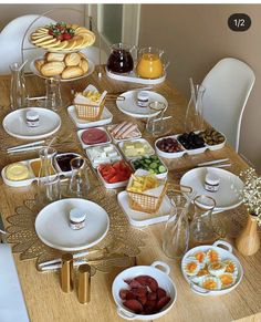 a wooden table topped with lots of plates and bowls filled with different types of food