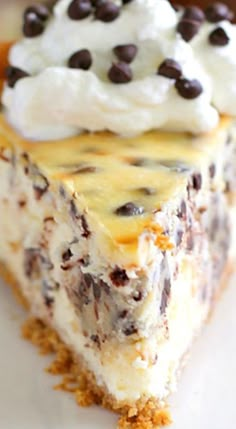 a piece of cheesecake with chocolate chips and whipped cream