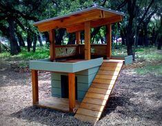 a dog house built into the side of a field