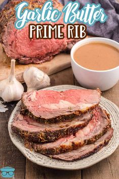 garlic butter prime rib on a plate next to some garlic