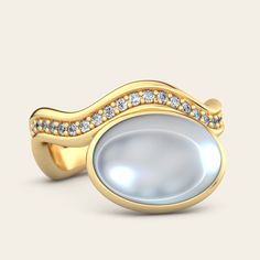 A glamorous touch to our Aurora Cocktail Ring. The addition of diamonds accentuates the stone of your choice, bezel set against two gently curving bands. The off-set stone placement evokes a bohemian sensibility, unexpected yet beautiful. 18k Yellow or White Gold Variations: Tanzanite (10x14mm) Moonstone (10x14mm) Turquoise (10x14mm) Rubellite (10x14mm) Diamonds (.45 cts) Polished Finish All stones are unique and reflect beautiful variations. Unsure of your size? Contact us for a ring sizing kit Luxury Moonstone Ring With Diamond, Elegant Diamond Topaz Ring, Elegant Topaz Ring With Diamond, Luxury White Topaz Ring With Bezel Setting, Elegant Topaz Ring With Center Stone, Luxury Moonstone Ring With Accent Stones, Luxury Oval Moonstone Ring With Diamonds, Elegant Moonstone Ring With Rose Cut Diamonds For Anniversary, Elegant Gold Moonstone Ring With Diamond Accents