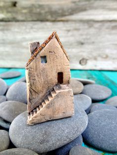 a small house sitting on top of some rocks