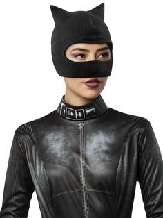 a woman wearing a black cat mask and leather jacket with zippers on the sides