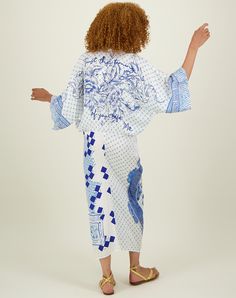 Mixed print v-neck kimono midi dress in shades of blue and lavender. Sleeves are wide. Dress is gathered at the waist and draped in the front. Mixed print geometric background. Features a large stylized dragon in front. There are several slogans on the dress such as “BLUE RIBBON”, “amour” and “Just Enjoy”. Back has a large floral graphic. Wear this dress for a summery relaxed look. Viscose 100% Stylized Dragon, Wide Dress, Coast Dress, Blue And Lavender, Blue Kimono, Hemant And Nandita, Sleepwear Dress, Kimono Dress, Geometric Background