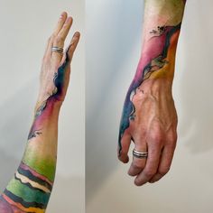 two hands with different colored tattoos on their arm and wrist, one holding the other's hand