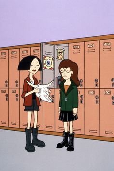 two women standing next to each other in front of lockers with animals on them