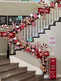 christmas decorations on the banisters and handrails in front of a staircase decorated with candy canes